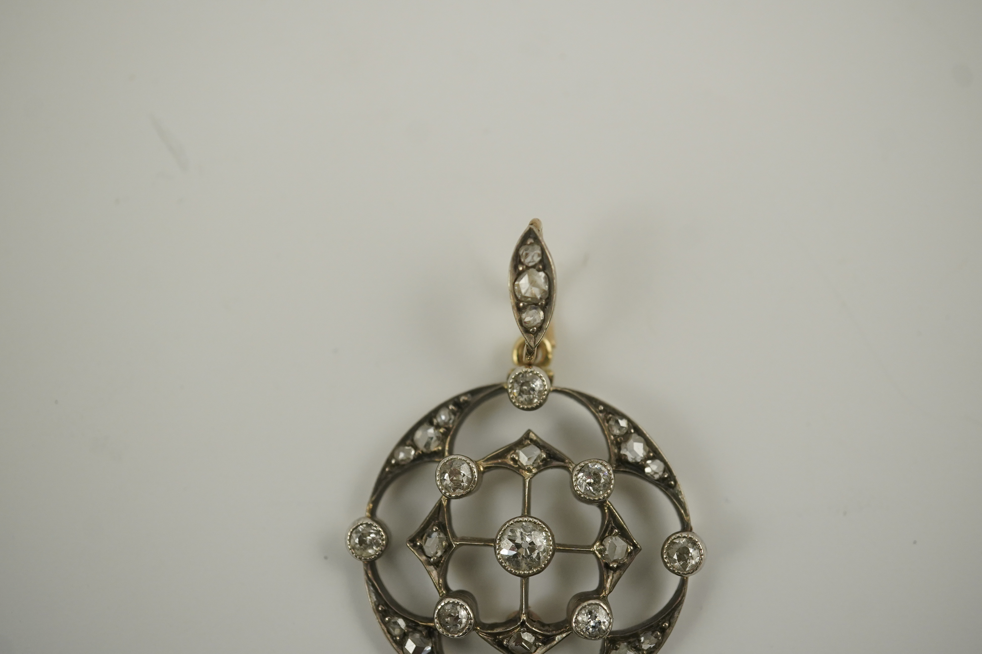 A cased Belle Epoque gold, rose and round cut diamond cluster set open work pendant/brooch